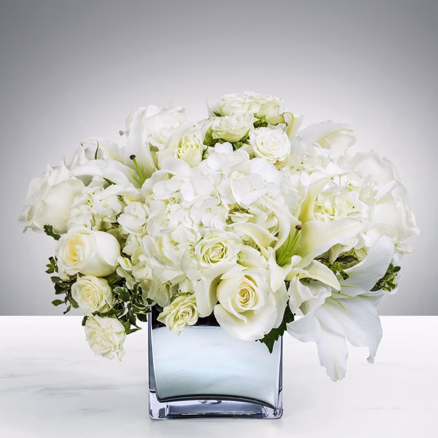Snowy Field white flower arrangement with roses hydrangeas lilies alstroemeria and fresh greenery