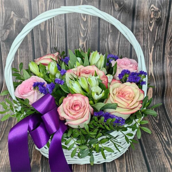 Pastel Daydream basket arrangement with cream pink and peach roses alstroemeria statice and eucalyptus
