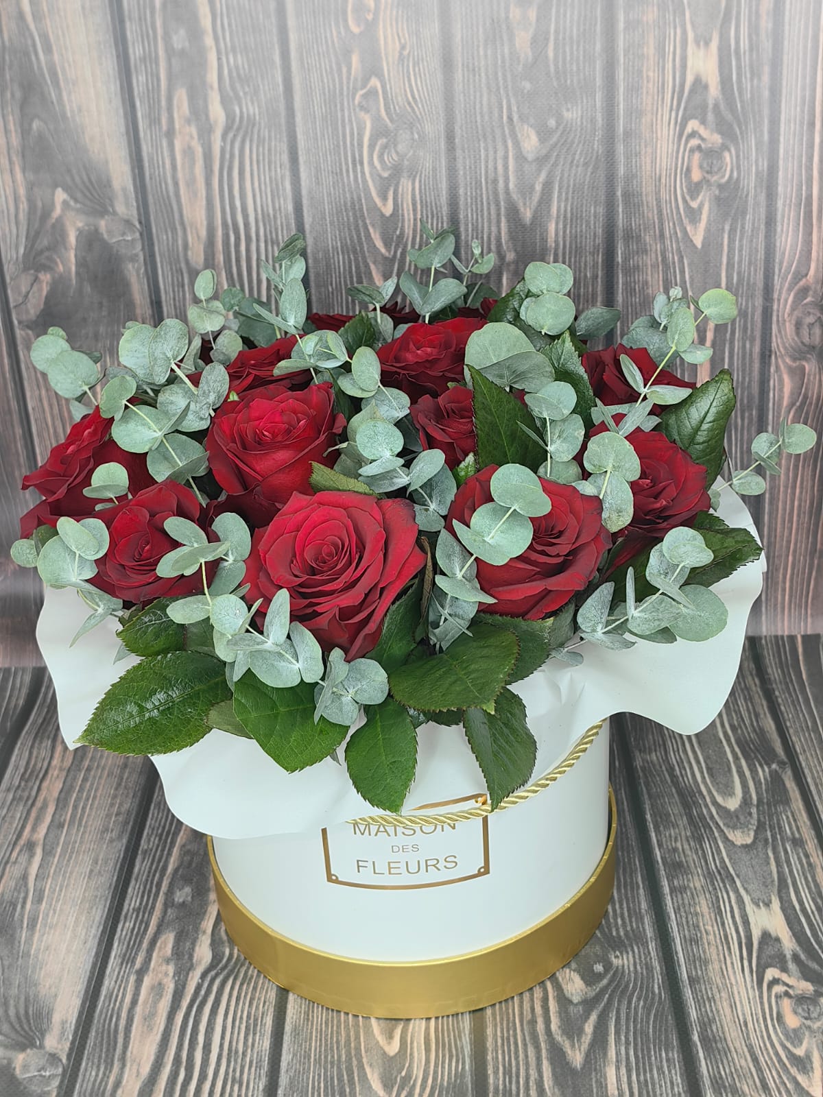 Rapture red rose bouquet with fresh eucalyptus in a white flower box