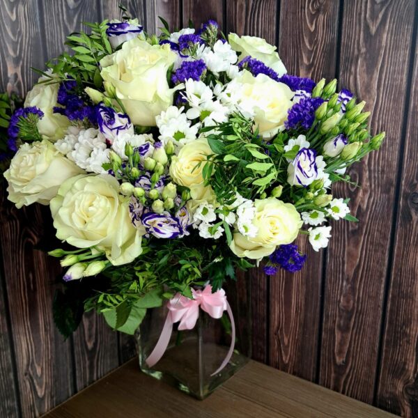 White roses and purple lisianthus bouquet with fresh greenery
