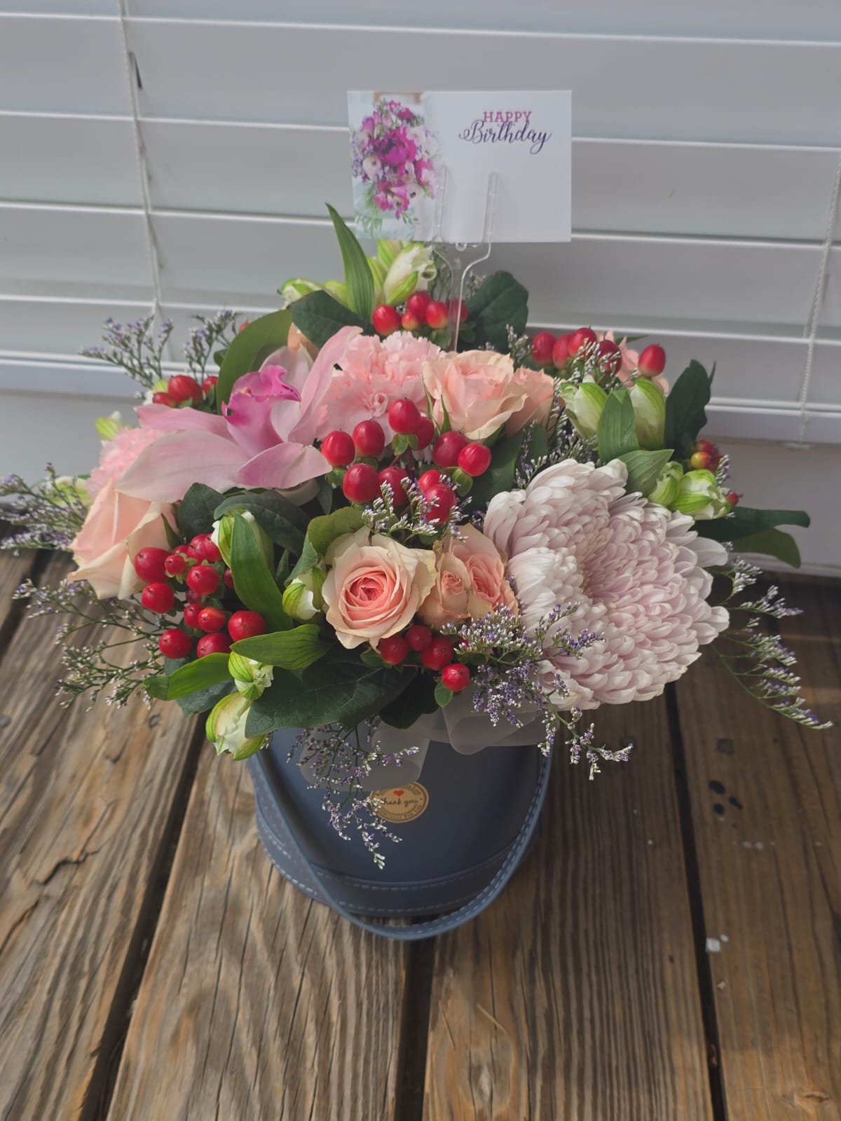 Delicate Grace flower arrangement with roses, chrysanthemums, alstroemeria, hypericum and orchids in a gray box
