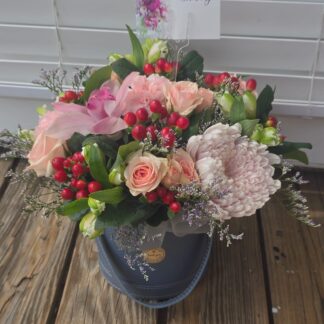Delicate Grace flower arrangement with roses, chrysanthemums, alstroemeria, hypericum and orchids in a gray box