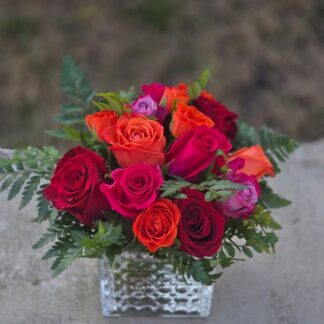 A bouquet of roses in a glass vase, a symphony of shades