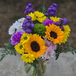 A bouquet in a glass vase with sunflowers. Sunny mood