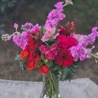 A bouquet in a glass vase with matthiola, spray roses, alstroemeria, and gerbera
