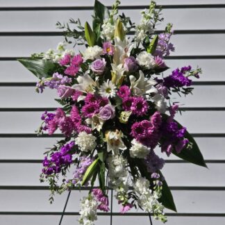 Funeral Standing Sprays & Wreaths  on a stand with lilies, lilac matthiola, roses, and white matthiola