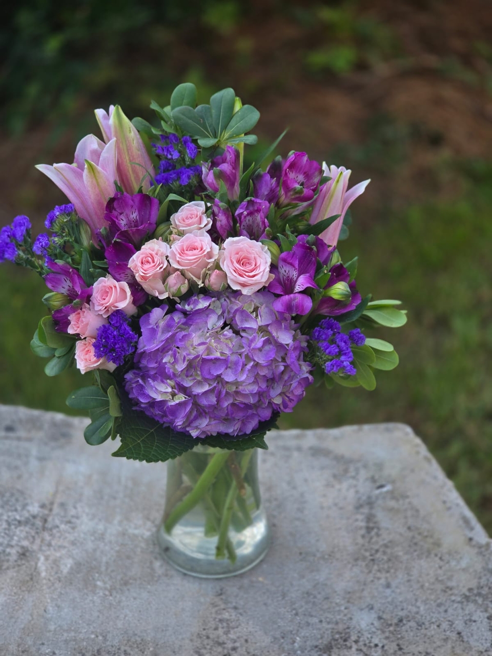 Luxury in every detail: a bouquet in a glass vase with lilac hydrangea, alstroemeria and pink lily