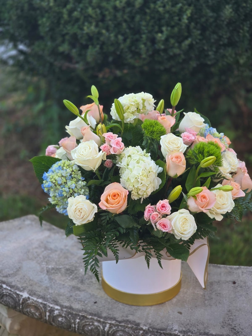 Garden Romance pink rose bouquet with hydrangea, white lilies, white roses and fern in a round box